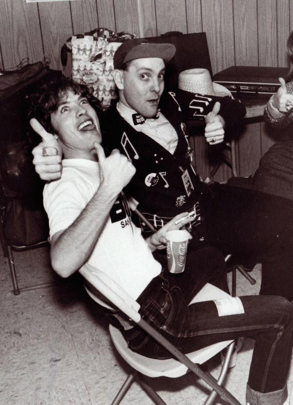 Rick Nielsen and Angus Young from AC/DC swapping grins and thumbs-up.
